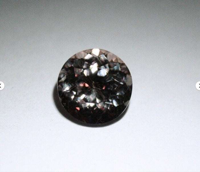 Colour Change Garnet 1.17ct Round Cut Rare Scintillating Gem Tanzania 6x6mm AAA